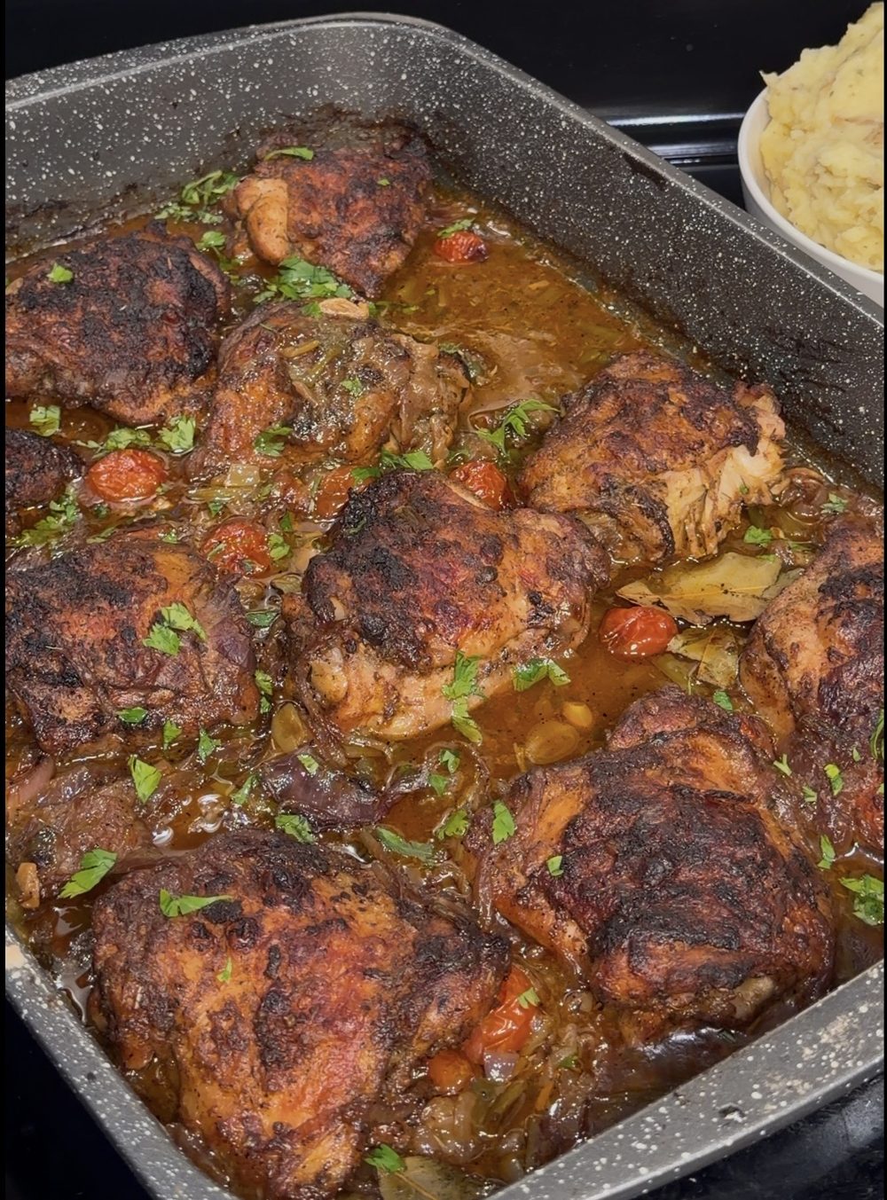 Lemon herb garlic chicken thighs in pan sauce with mashed potatoes