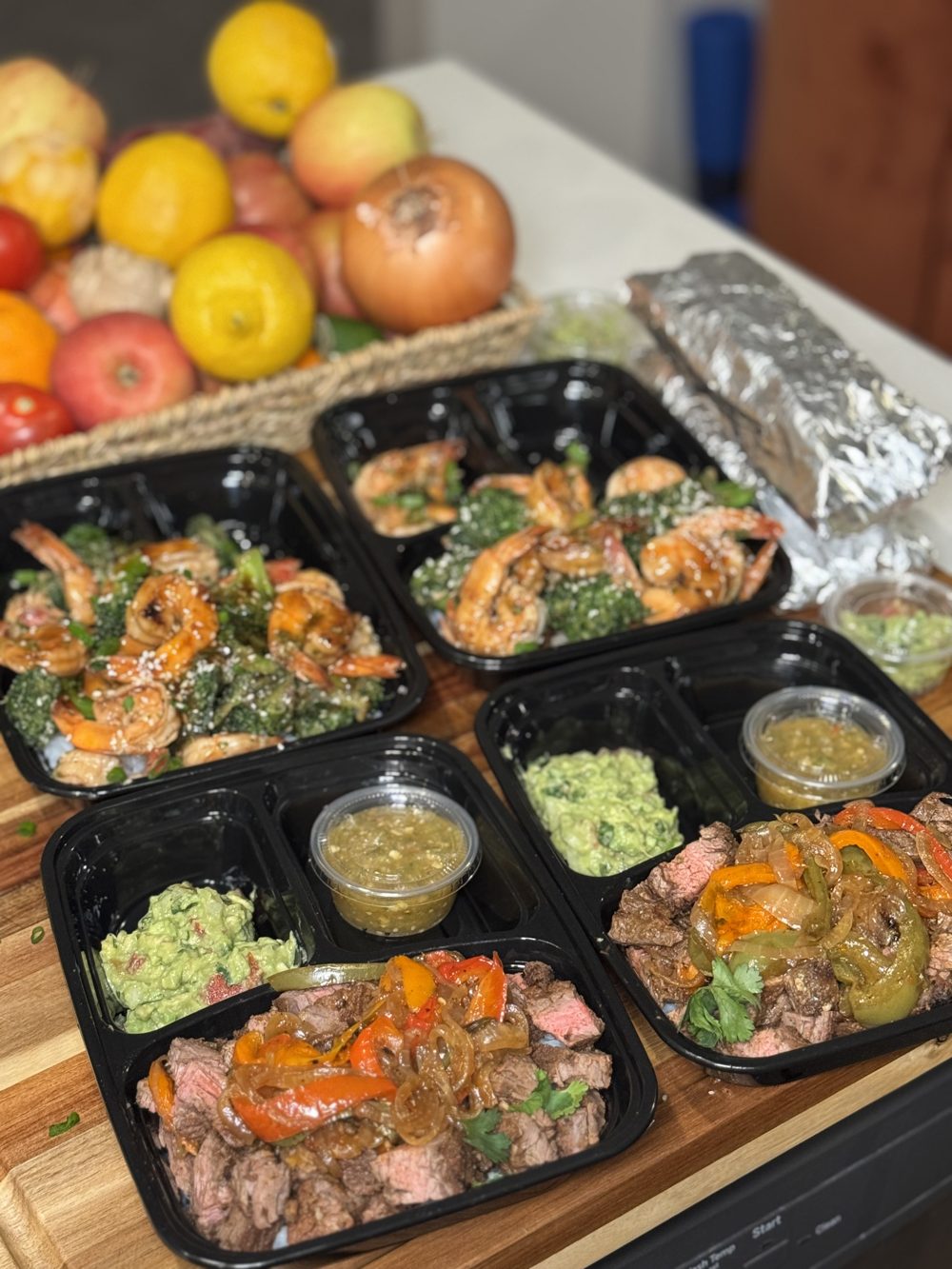 Steak fajitas with guacamole and salsa, and teriyaki shrimp with broccoli